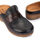 A pair of Pikolinos women's leather slip-on clogs shown on a white background, featuring a dark brown leather upper with a contrasting medium brown strap, a tan insole, and a brown textured sole.