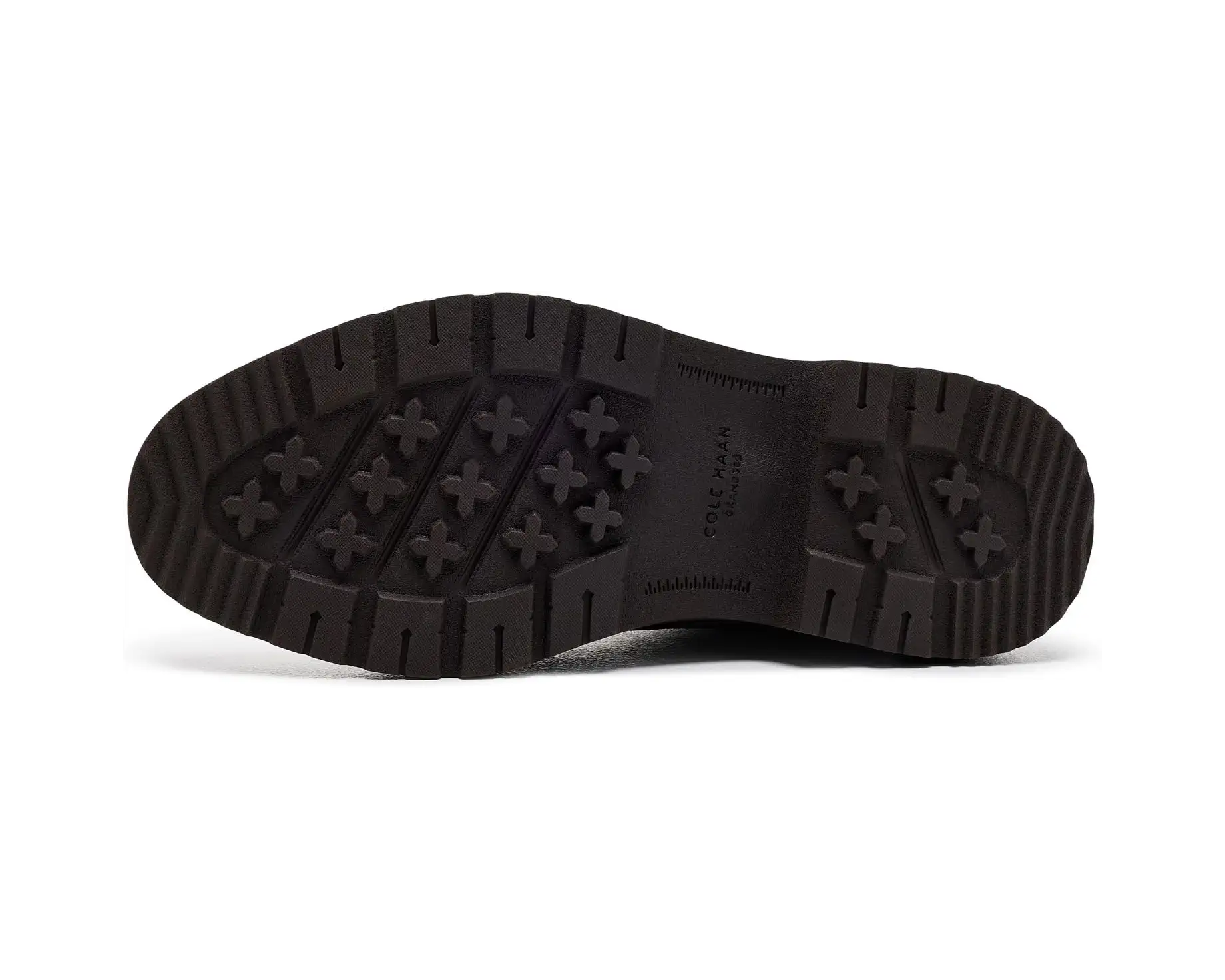 The black rubber outsole of a boot, showing a detailed tread pattern with cross-shaped lugs and the embossed brand name 'COLMAN'.