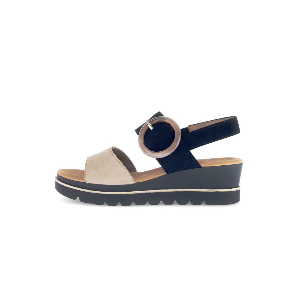 Navy sandal with beige sole on a white background