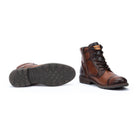 Brown leather boot with sole showing on a white background