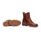 Brown leather boot with a zipper on a white background