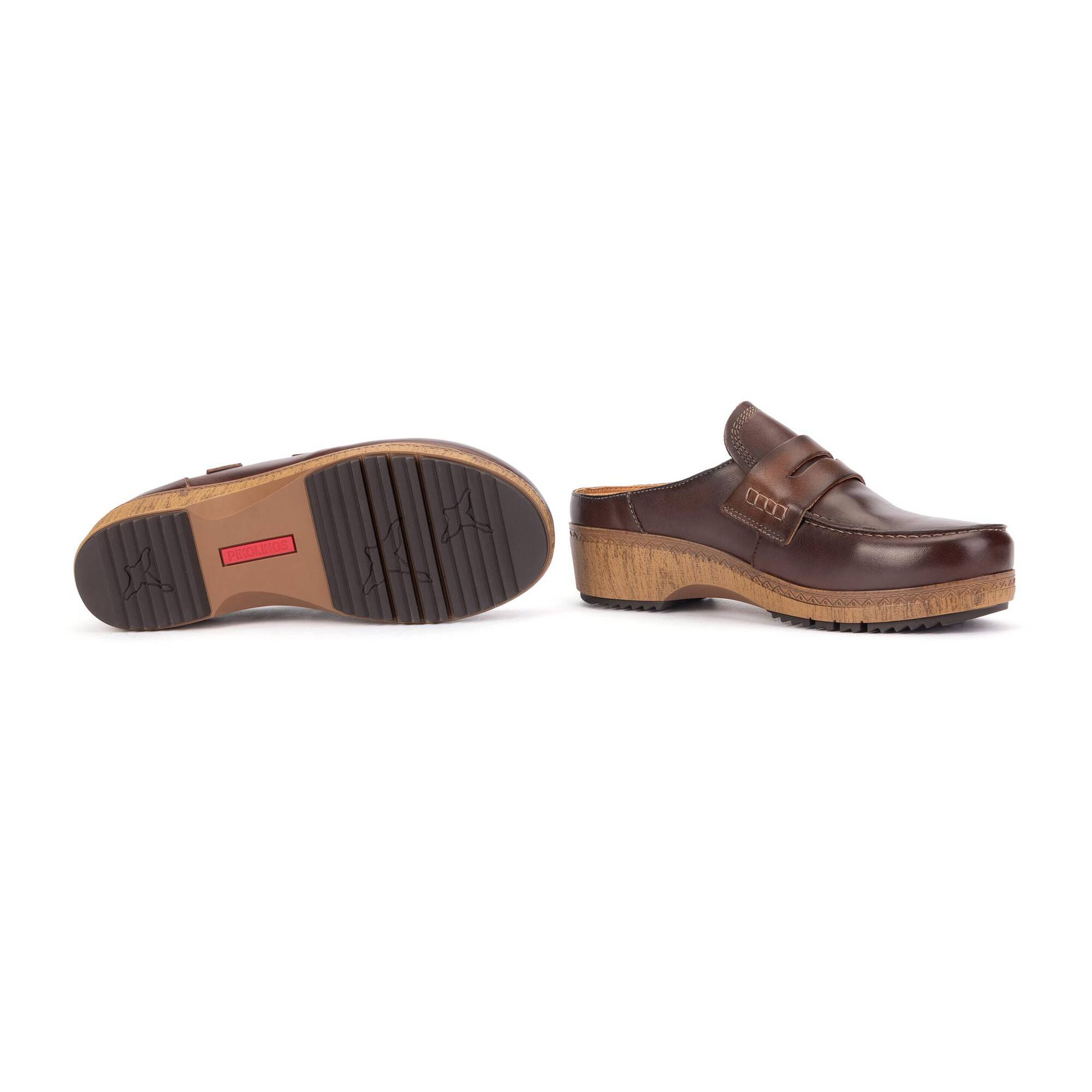 A pair of dark brown leather clog-style mules shown on a white background, with one shoe displaying the side profile and the other showing the outsole.