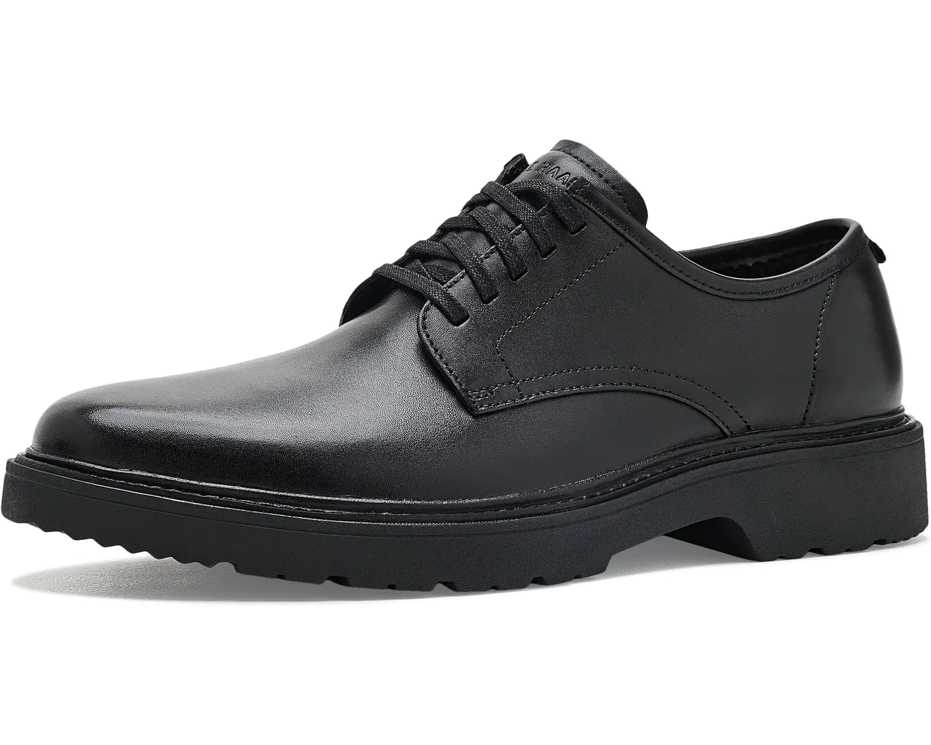 A single black leather lace-up dress shoe with a chunky black sole, shown from a side profile on a white background.