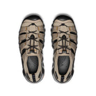 Pair of beige and black hiking shoes on a white background