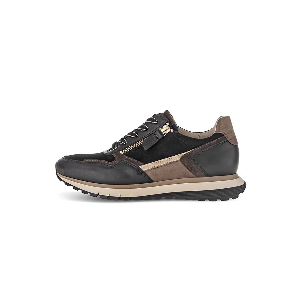 Black and brown sneaker with a gold zipper on a white background