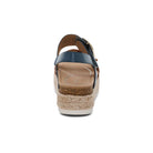 Wedge sandal with blue strap and cork wedge on a white background