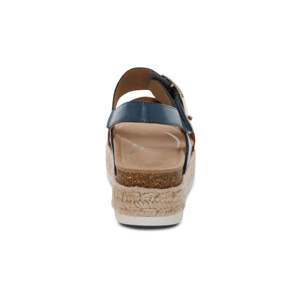 Wedge sandal with blue strap and cork wedge on a white background