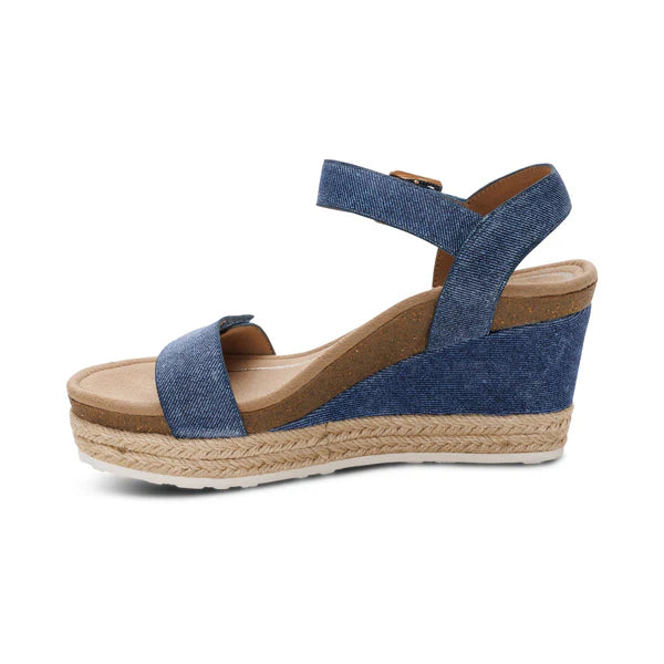 Blue wedge sandal with espadrille sole on a white background
