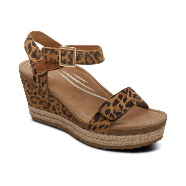 Brown wedge sandal with leopard print straps on a white background