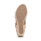 Beige sandal with a textured sole on a white background