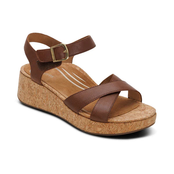 Brown wedge sandal with cork sole on a white background