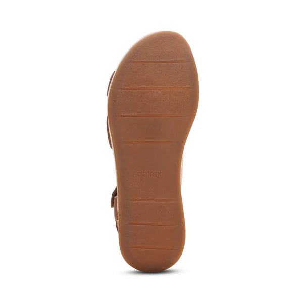 Brown sandal sole with 'aetrex' branding on a white background