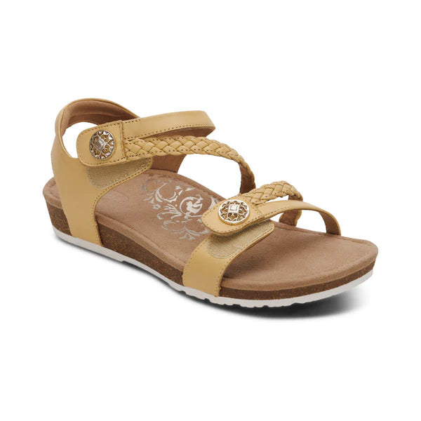 Beige sandal with braided design on a white background