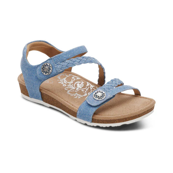 Blue sandal with cork wedge sole on a white background