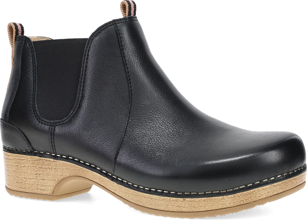 A black leather Chelsea boot with a natural wood-look stacked heel and contrast stitching, shown from a three-quarters angle on a white background.