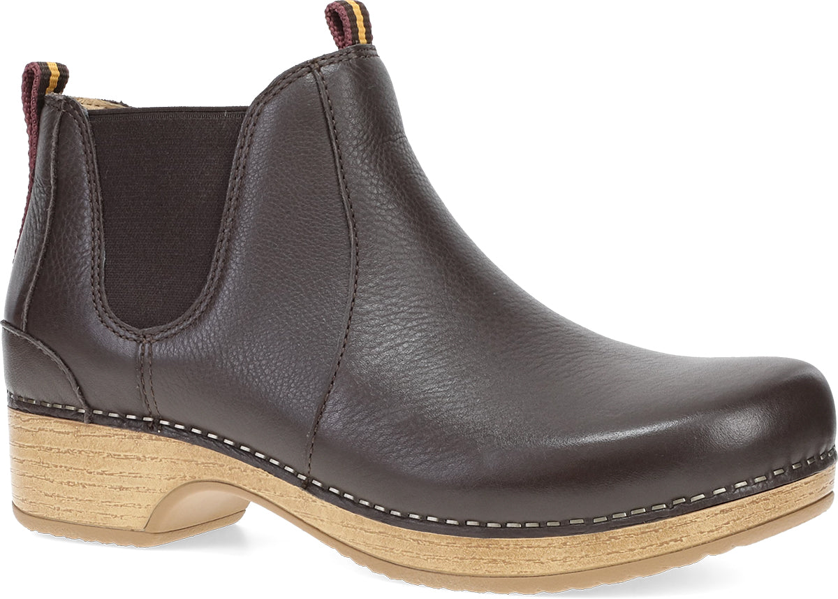 A black leather Chelsea boot with a natural wood-look stacked heel and contrast stitching, shown from a three-quarters angle on a white background.