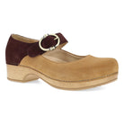 Tan clog shoe with brown strap and buckle on a white background