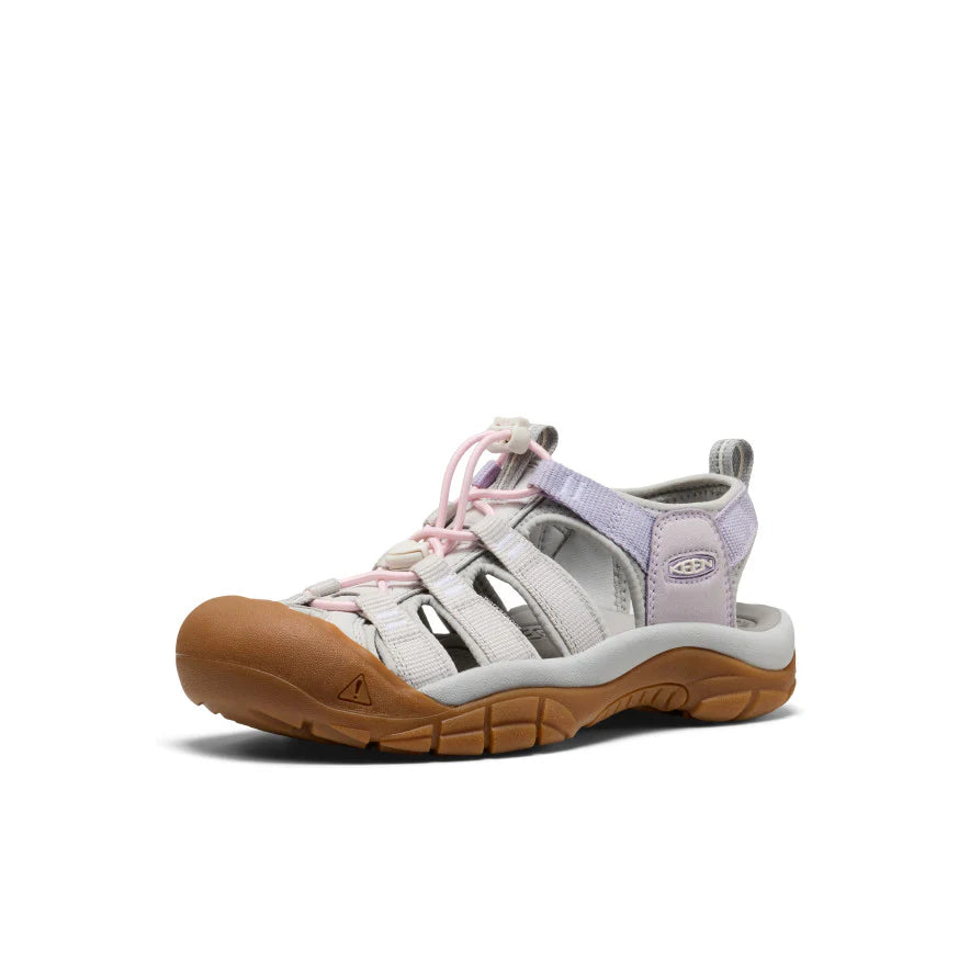 White sandal with brown sole and pink laces on a white background