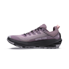 A single GORE-TEX trail running shoe in a dusty lavender-purple colorway, featuring a black midsole and black laces, shown in a side profile on a white background.