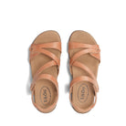 Pair of tan sandals with 'taos' branding on a white background