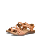 Pair of tan sandals on a white background