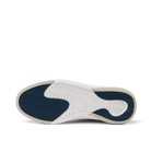White sneaker sole with blue tread pattern on a white background