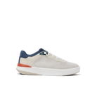 White sneaker with blue and red accents on a white background