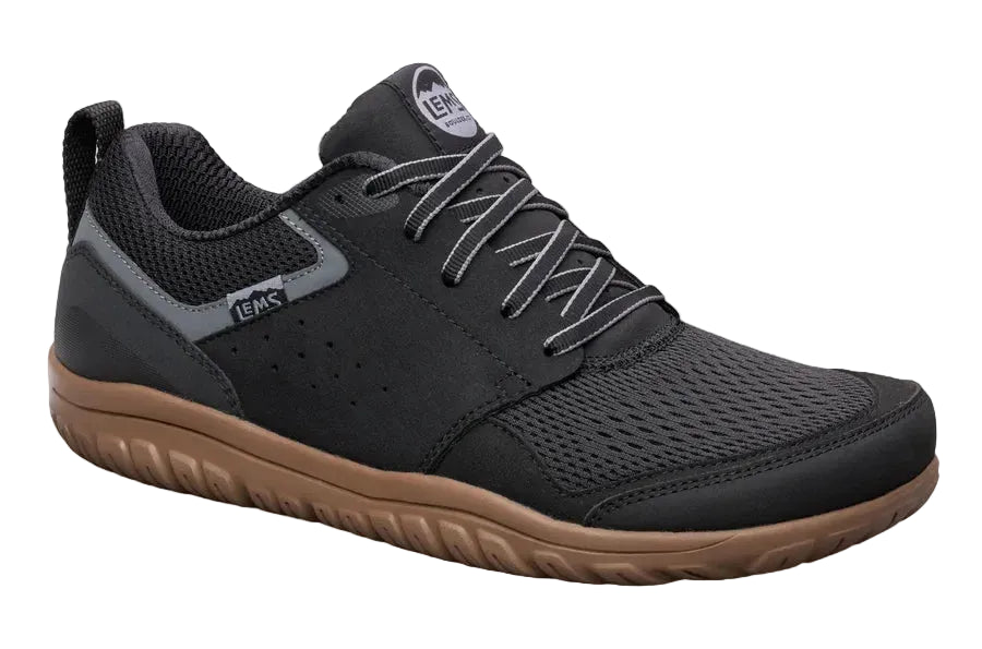 Black sneaker with brown sole on a white background
