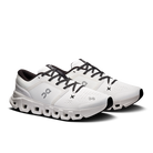 White running shoes with black laces on a white background