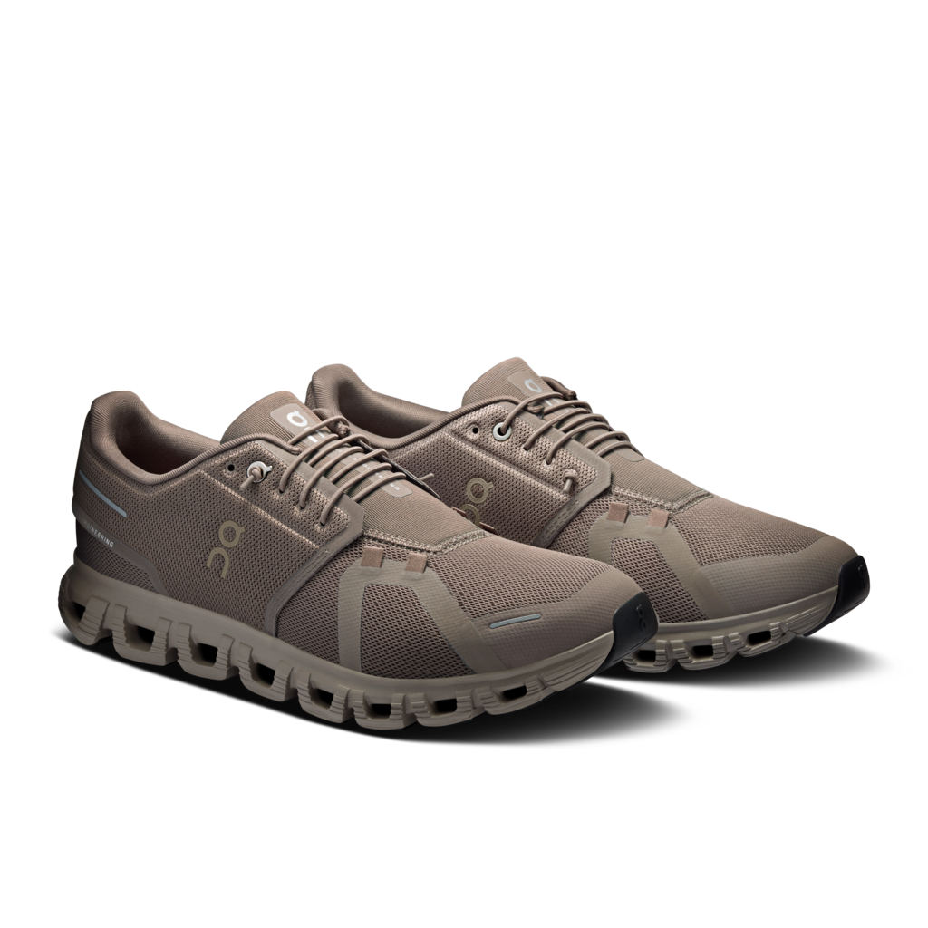 Pair of brown running shoes on a white background