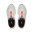 White running shoes with orange accents on a white background
