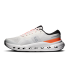 White running shoe with orange accent on a white background