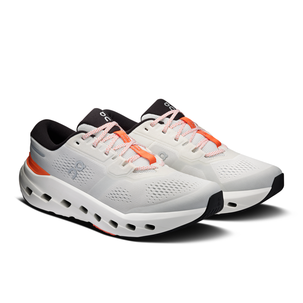 White running shoes with black and orange accents on a white background