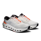 White running shoes with black and orange accents on a white background