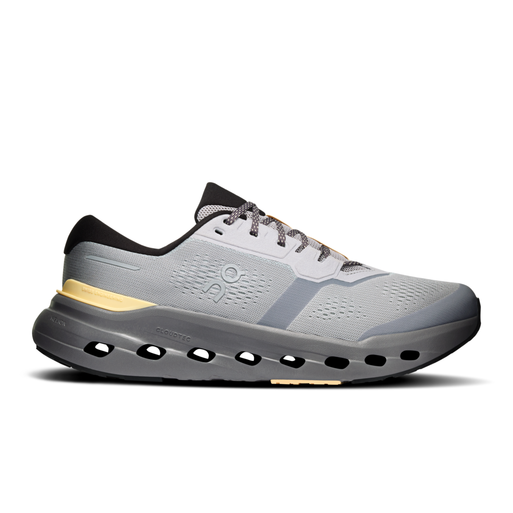 A light gray and dark gray running shoe with black accents and a small yellow accent near the heel, shown in a side profile on a white background.