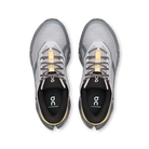 A pair of On Cloudrunner trail running shoes shown from a top-down view, featuring a light gray and white mesh upper with black and gray details, black laces, and a gold accent on the tongue and inner sole.