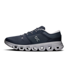 A dark navy blue On running shoe with a chunky light gray sole, shown in a side profile on a white background.