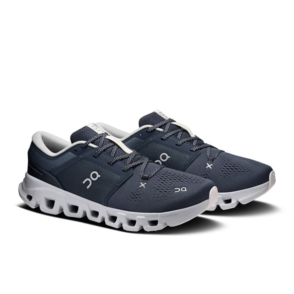 A pair of On running shoes in navy blue and white, featuring the brand's logo on the side, set against a plain white background.