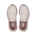 Pair of beige running shoes with a visible brand logo on a white background
