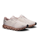 White and pink sneakers with unique sole design on a white background