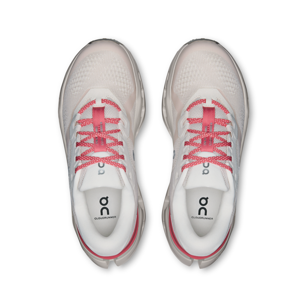 White running shoes with pink laces on a white background