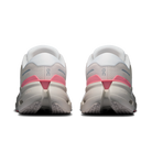 White and pink running shoes on a white background