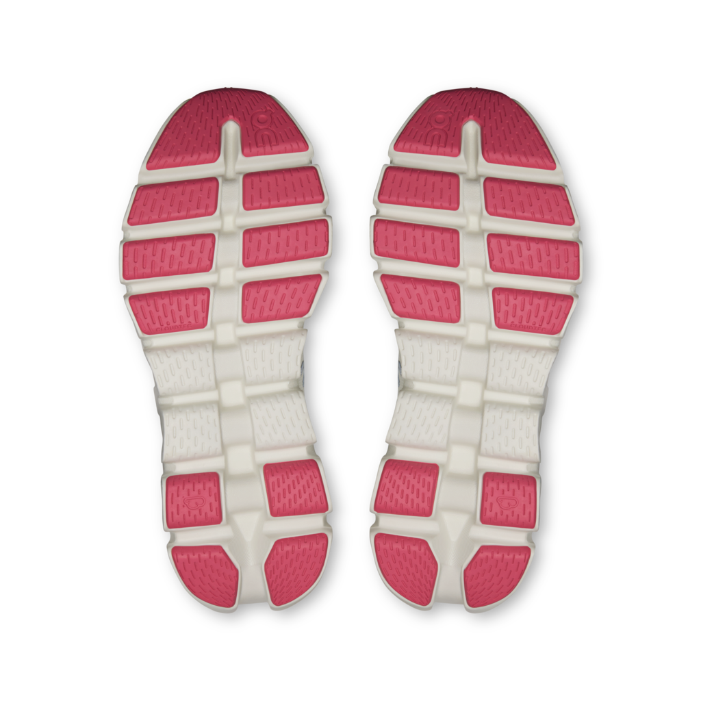 A pair of athletic shoe soles viewed from above, featuring a white textured midsole with bright pink textured outsole blocks.