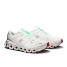 A pair of white On running shoes with mint green laces and accents, and red outsole details, shown on a clean white background.