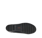 A top-down view of a black shoe sole with vertical tread grooves and the brand name 'taos' printed in orange on the heel, set against a plain white background.
