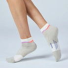 Gray ankle socks with colorful accents worn by a person on a light gray background