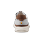 White sneaker with brown accents on a white background