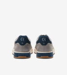 Gray and blue sneakers with a brand logo on a white background
