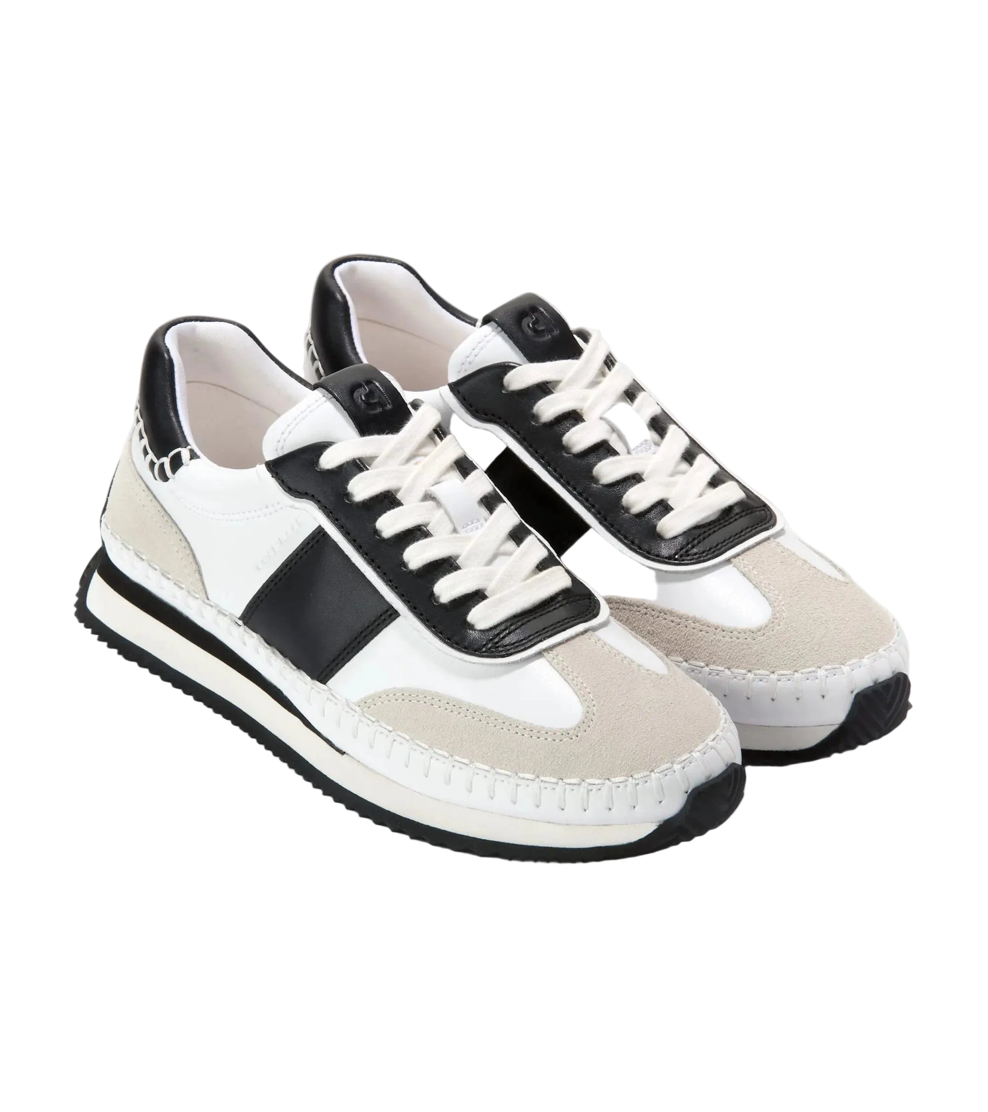 Pair of black and white sneakers on a light gray background