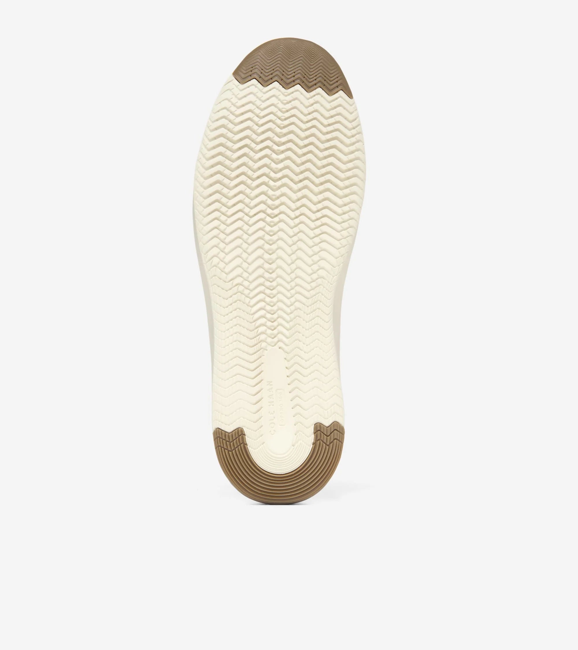 The outsole of a shoe shown from the bottom, featuring a cream-colored center with a wavy tread pattern and brown protective rubber caps at the toe and heel, on a light gray background.
